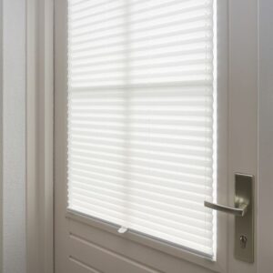 White framed honeycomb cellular shade installed on a door