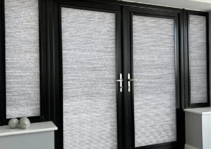 Plain white roller shade in a bright workspace